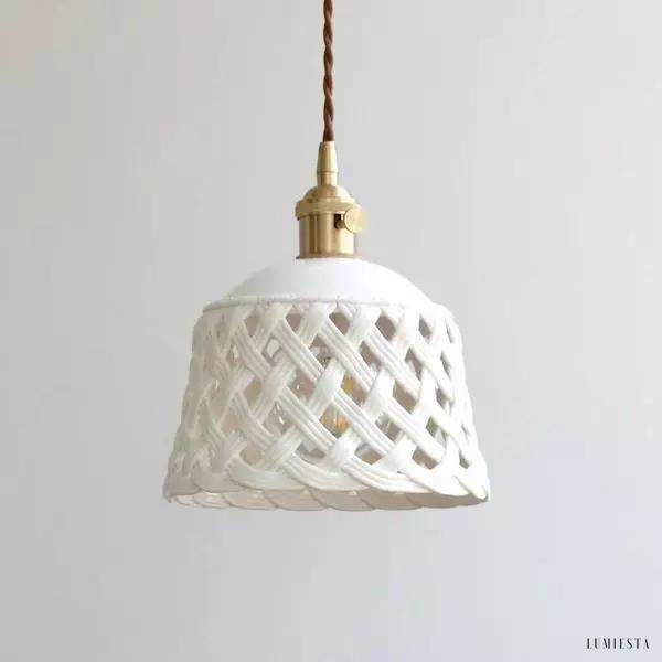 Openwork ceramic lamp with a hand-carved shade