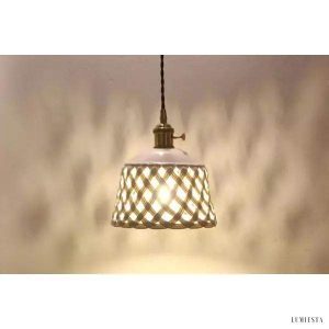 Openwork ceramic lamp with a hand-carved shade