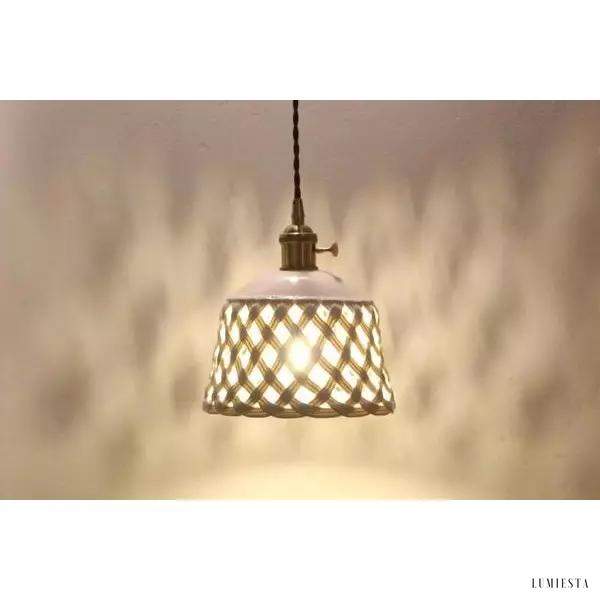 Openwork ceramic lamp with a hand-carved shade