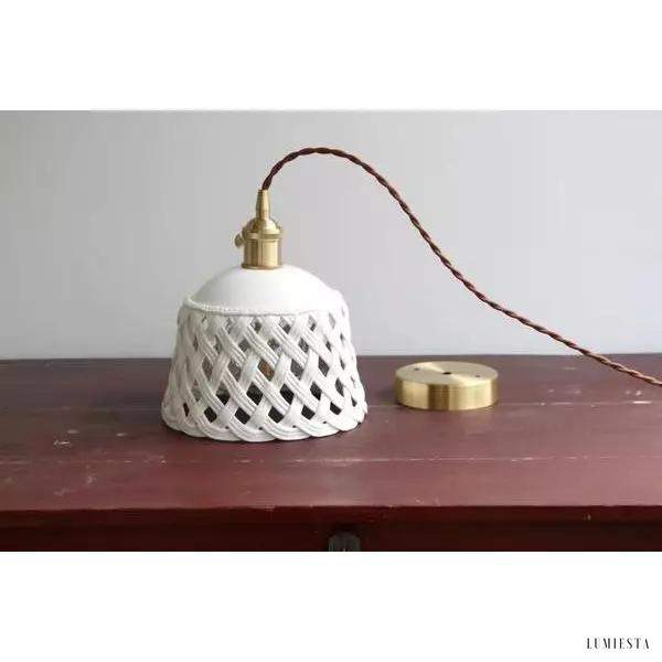 Openwork ceramic lamp with a hand-carved shade