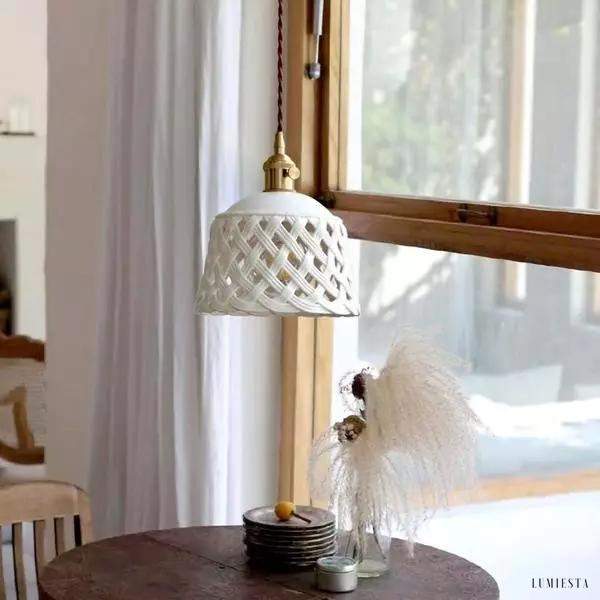 Openwork ceramic lamp with a hand-carved shade