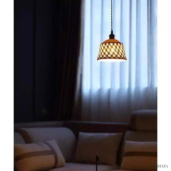Openwork ceramic lamp with a hand-carved shade