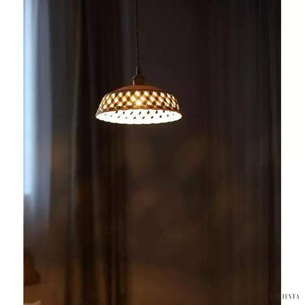 Openwork ceramic lamp with a hand-carved shade