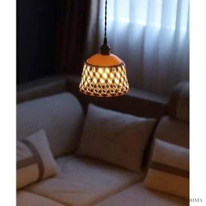 Openwork ceramic lamp with a hand-carved shade