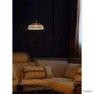Openwork ceramic lamp with a hand-carved shade