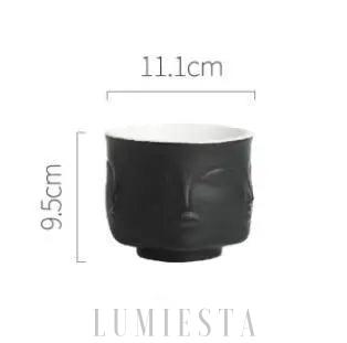 Ceramiczna doniczka w kształcie twarzy złoto czarna z wyraźnie zaznaczonymi rysami twarzy