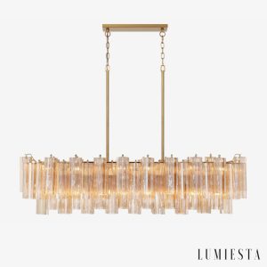 Żyrandol glamour złoty Bagliore Ø132 cm — podłużna lampa wisząca ze szkłem i metalem na białym tle