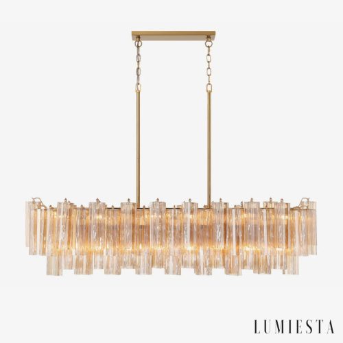 Żyrandol glamour złoty Bagliore Ø132 cm — podłużna lampa wisząca ze szkłem i metalem na białym tle
